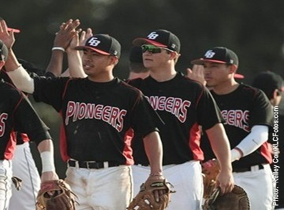 three CSUEB baseball players high-fiving the rival team.